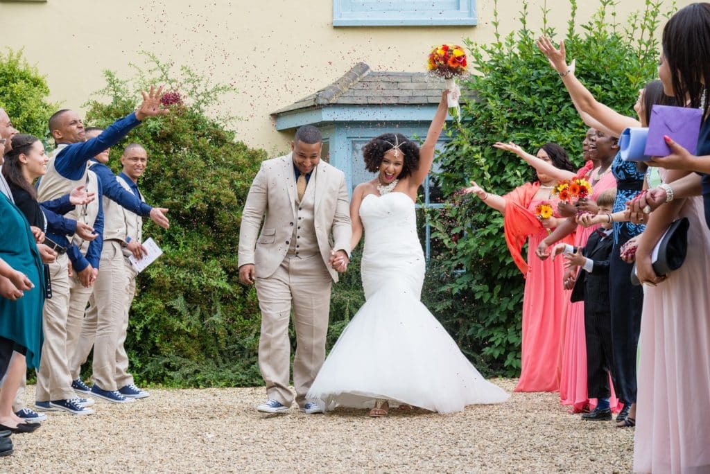 Wedding Couple showered with confetti by their guests at South Farm 