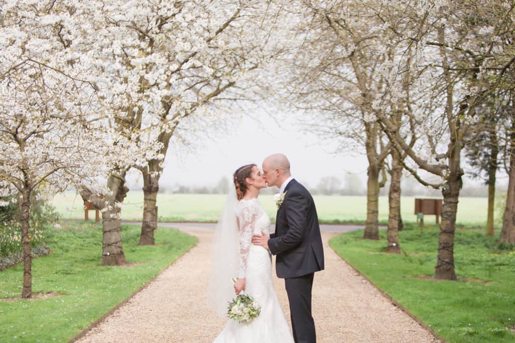 South Farm Cherry Blossom Just married couple share a kiss
