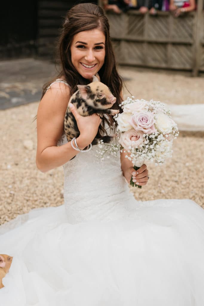 Bride at Farm Wedding Venue holding Piglet