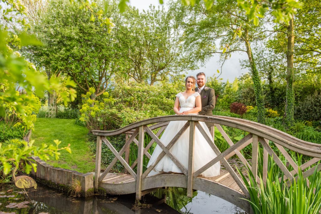 Bride and Groom on Garden Bridge at South Farm Wedding Venue