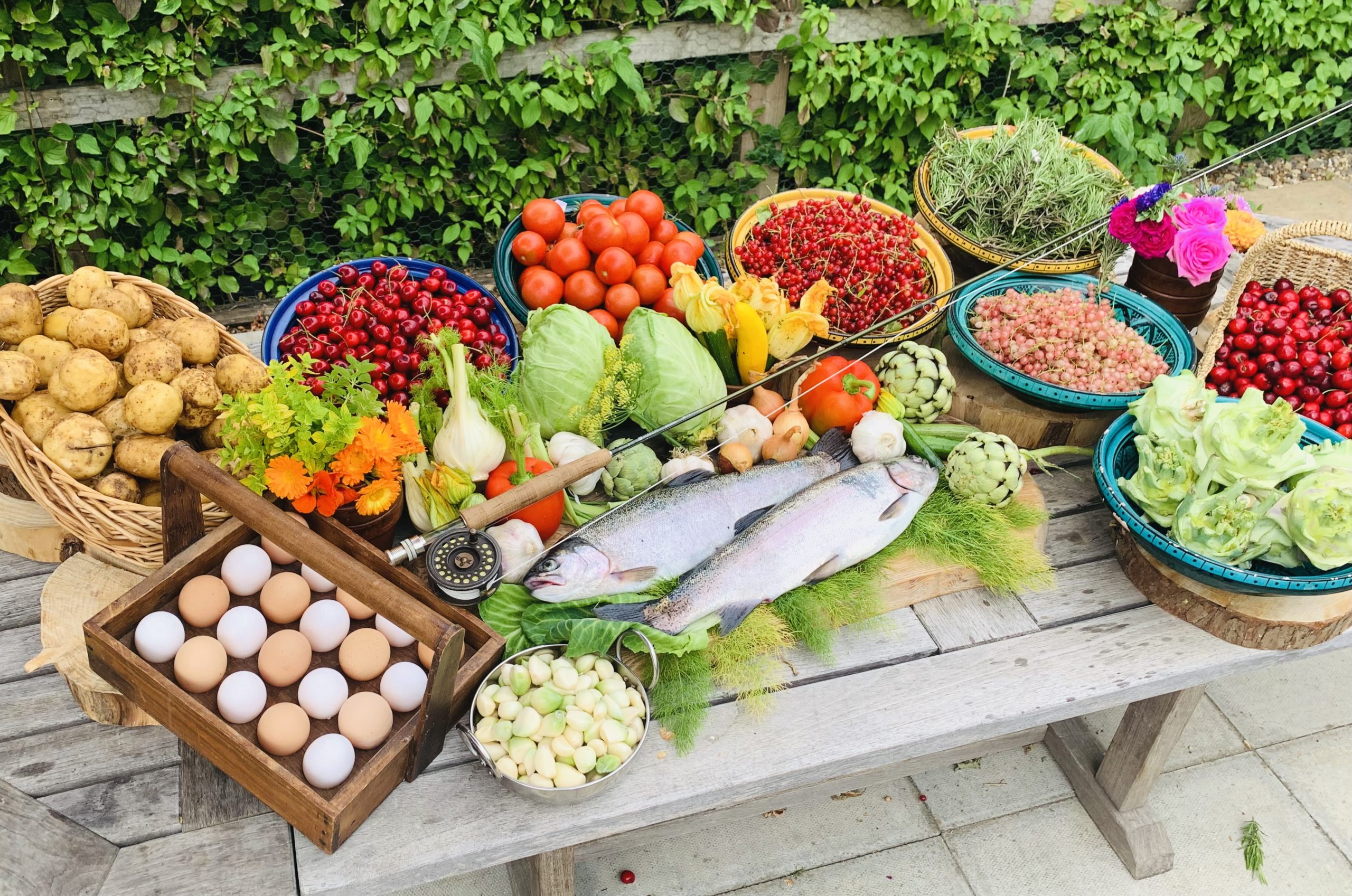 Colourful display of home Grown Fruit vegetables and herbs. free range eggs and hand caught trout