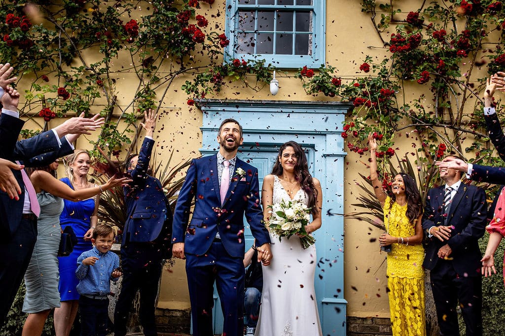 Confetti Photo in front of blue door of country farm house 
