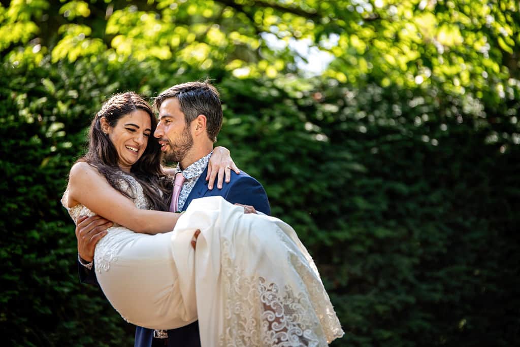 Groom Carries Bride just after they get married at garden wedding venue